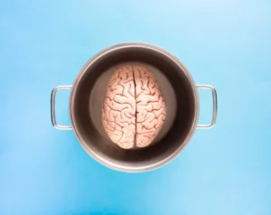 Man holding a brain model, demonstrating brain training and improvement